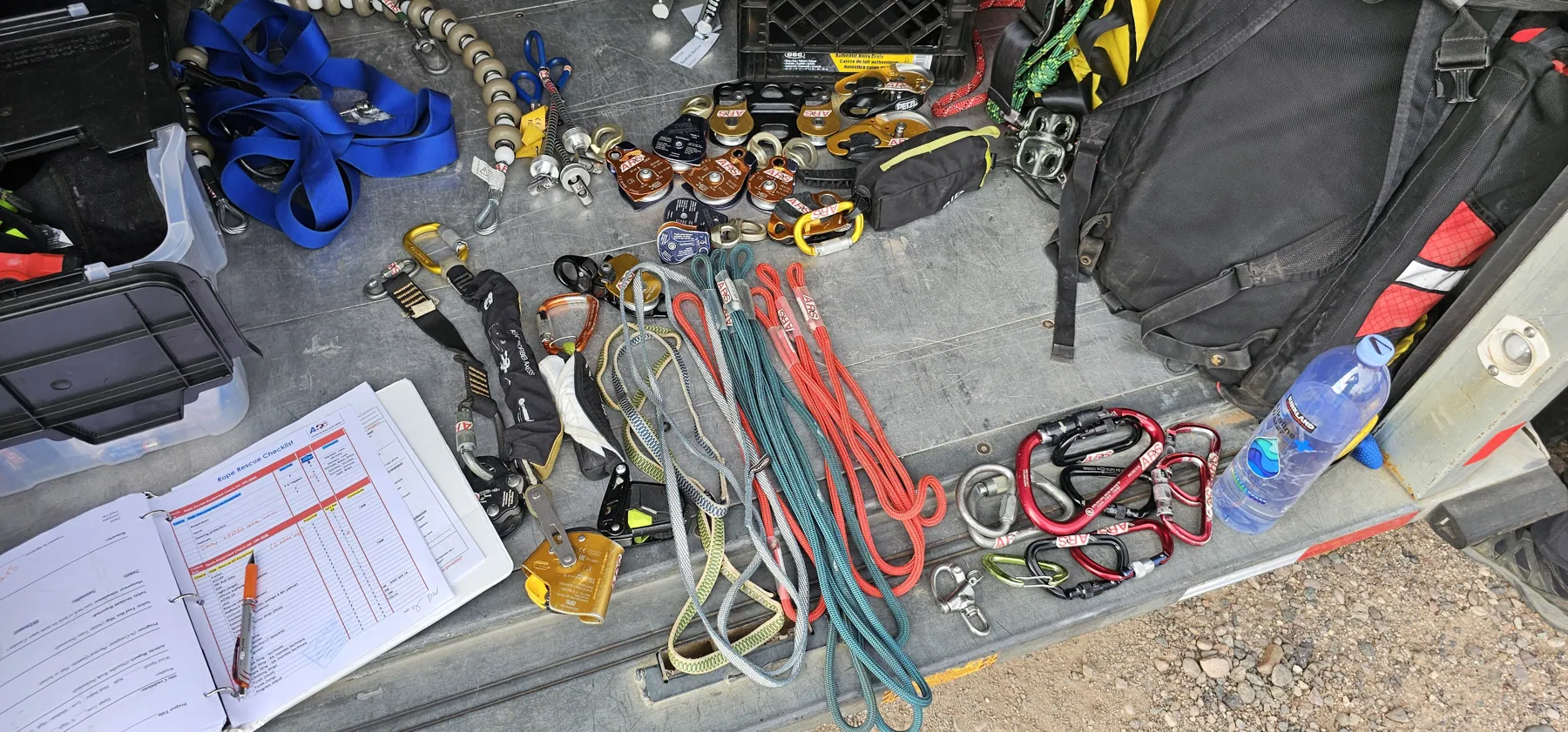 Ropes, hardware and written job paperwork laid out for a pre-job equipment check