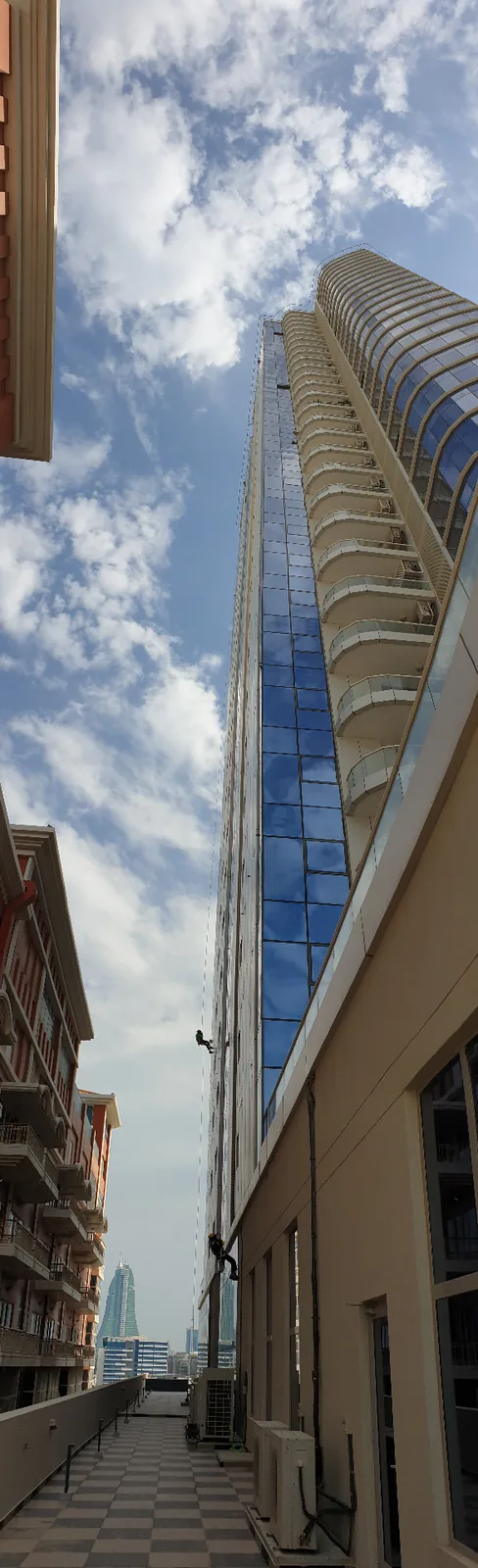 ARS rope access technician descending a high-rise facade